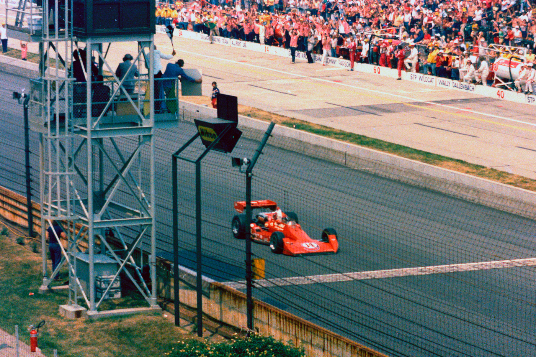 Эй Джей Фойт пересекает финиш Инди-500 1977 года. Тогда он стал первым пилотом, выигравшим эту гонку четыре раза